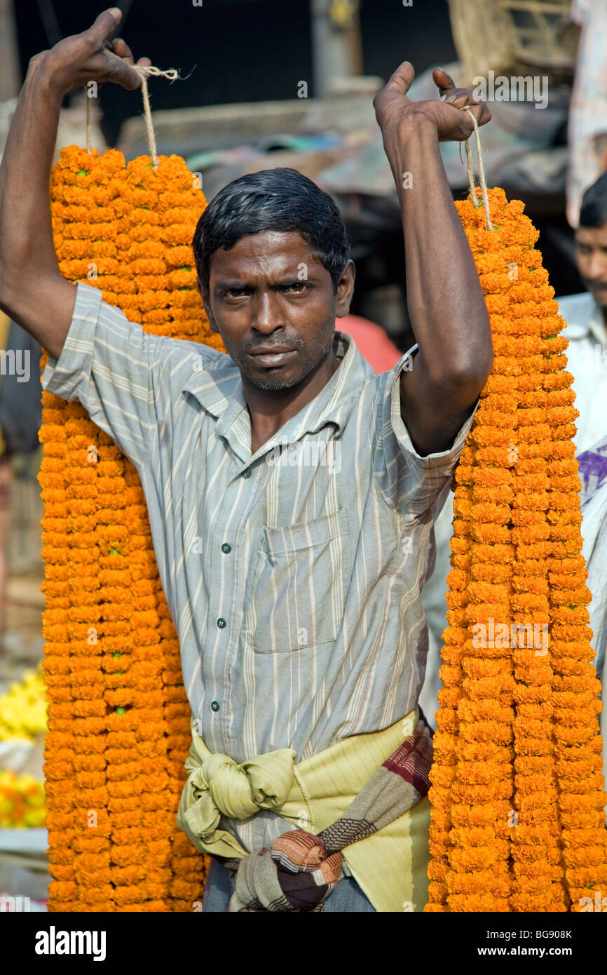 Indian men carrying flower garlands. Flower Market. Calcutta (Kolkata) Stock Photo