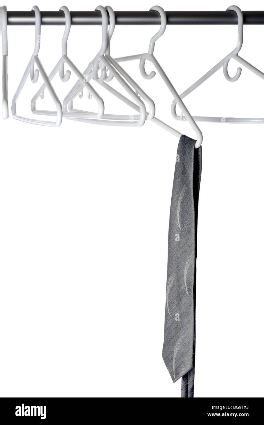 A gray tie on a clothes hanger on a closet rod Stock Photo