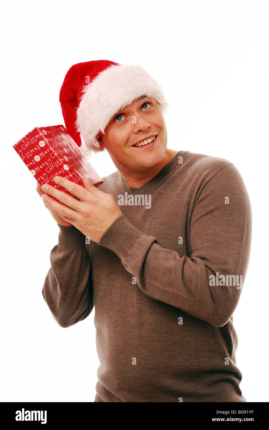 Smiling santa holding present hi-res stock photography and images - Alamy