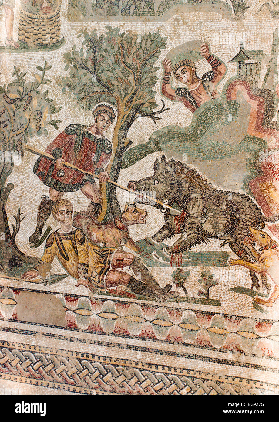 The Wild Boar Hunt mosaic detail. A man lifts a rock high above his head to strike a wild boar dead while another uses a spear Stock Photo