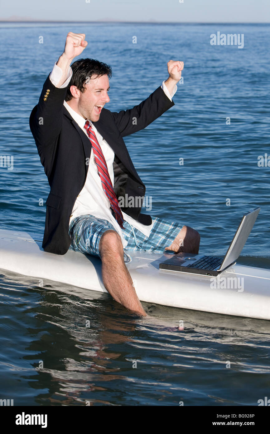 Young man having fun on a working vacation. Stock Photo