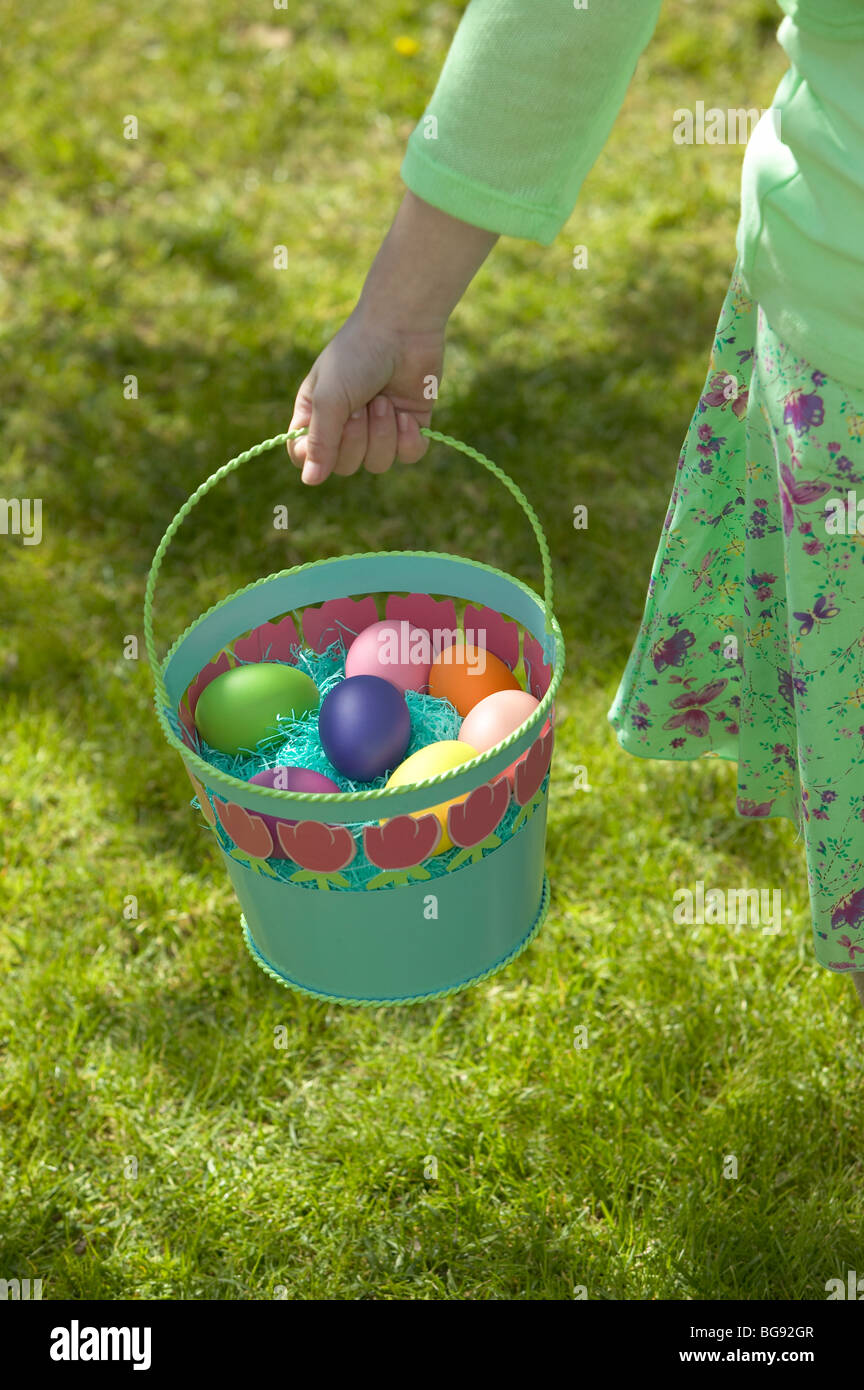 Girl holding Easter egg basket while walking on lawn Stock Photo Alamy