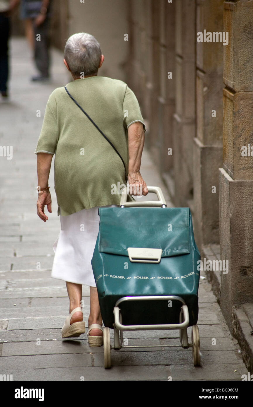 A old woman man pulling a shopping trolley Barcelona Spain Stock Photo -  Alamy