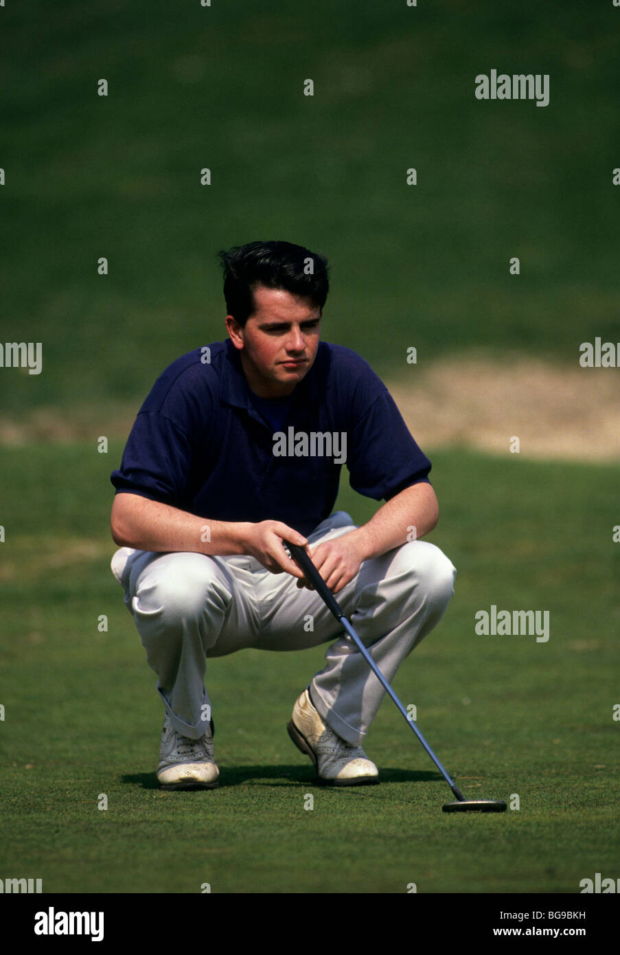 Golfer analyses his next shot Stock Photo