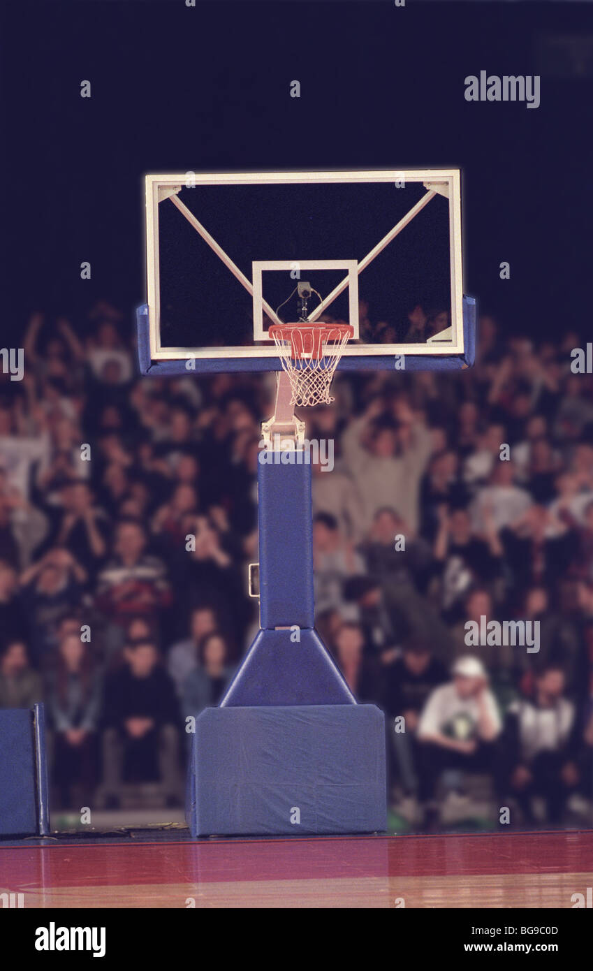 Basketball hoop and net with crowd in background Stock Photo - Alamy