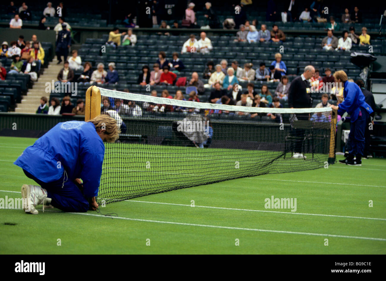Officials setting up a tennis court net Stock Photo Alamy