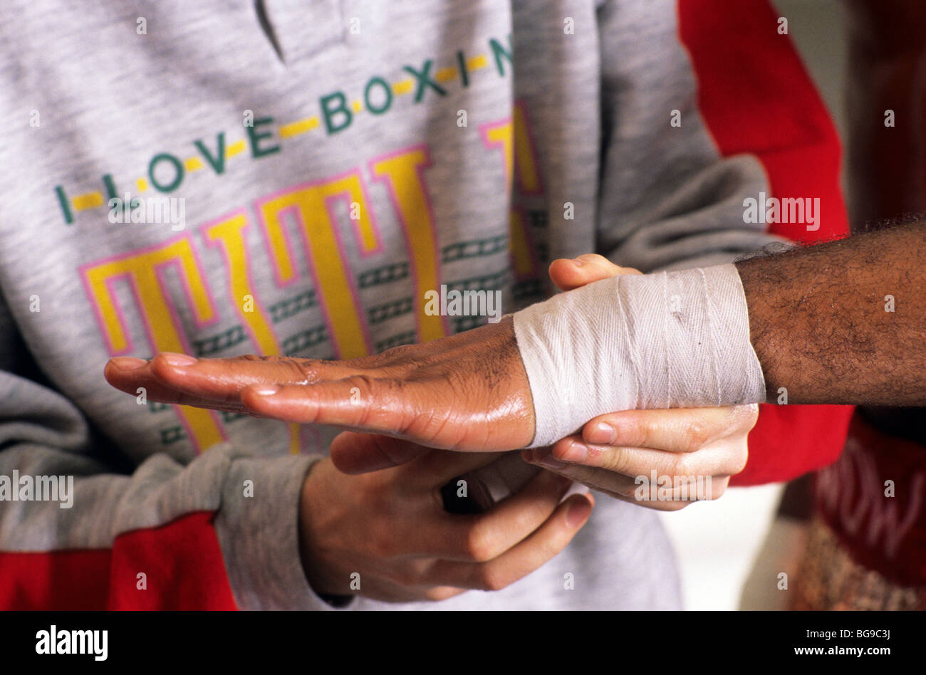 Trainer taping up a boxers hand Stock Photo Alamy