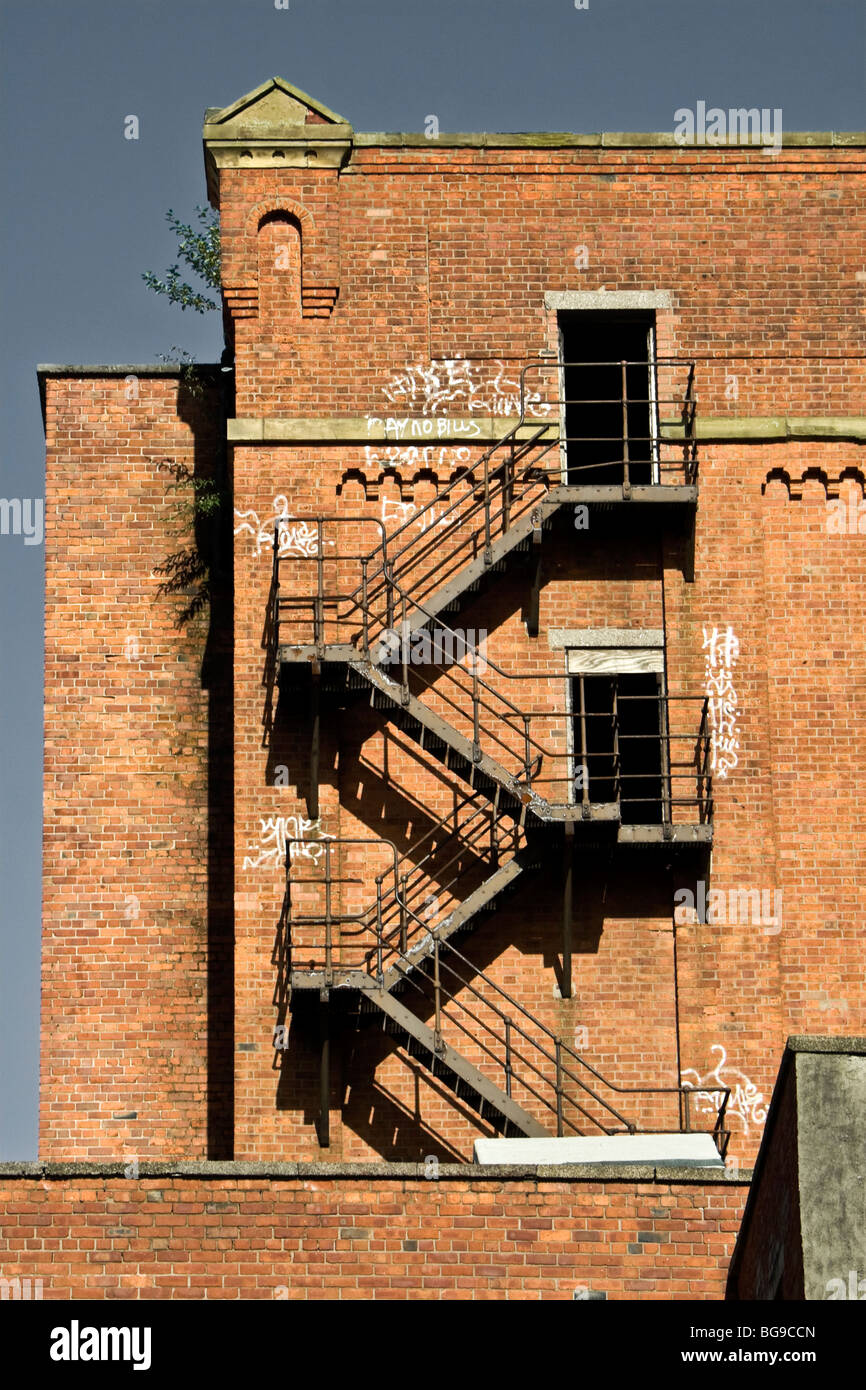 Fire escape and graffiti on old mill, Salford, Greater Manchester, UK Stock Photo