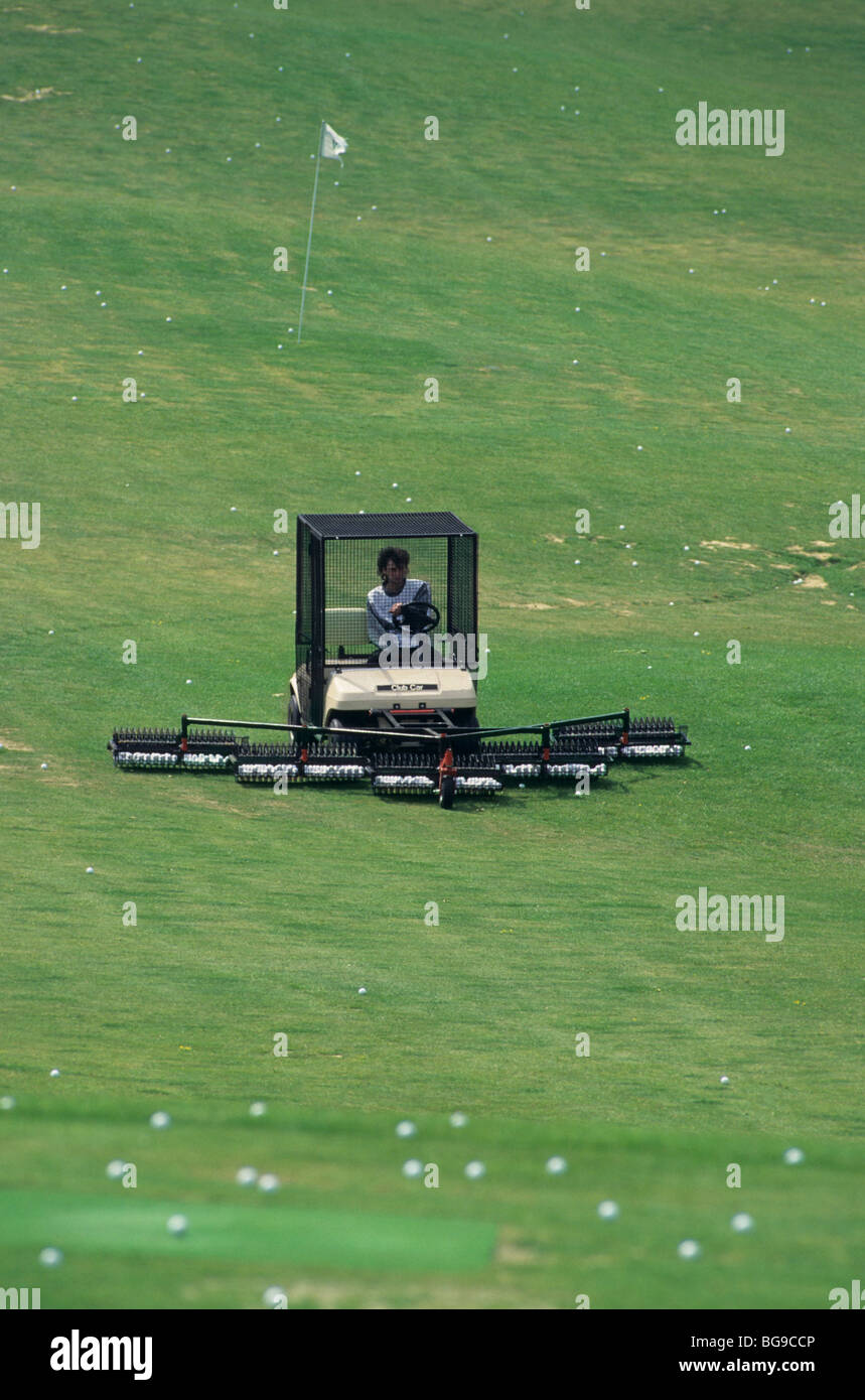 Mechanised golf ball collector on the practice tee Stock Photo - Alamy