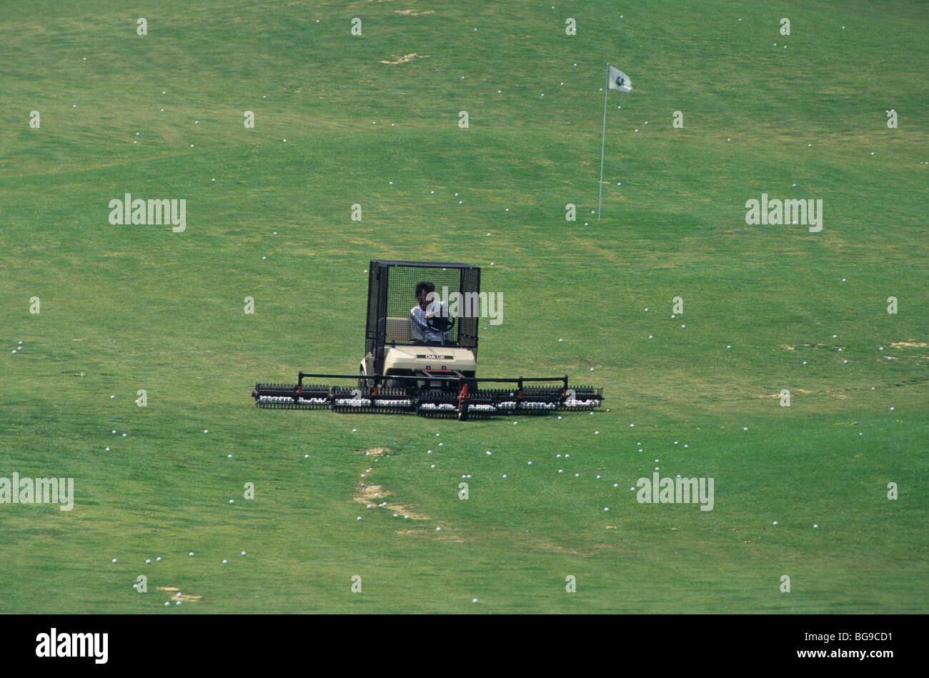 Mechanised golf ball collector on the practice tee Stock Photo Alamy