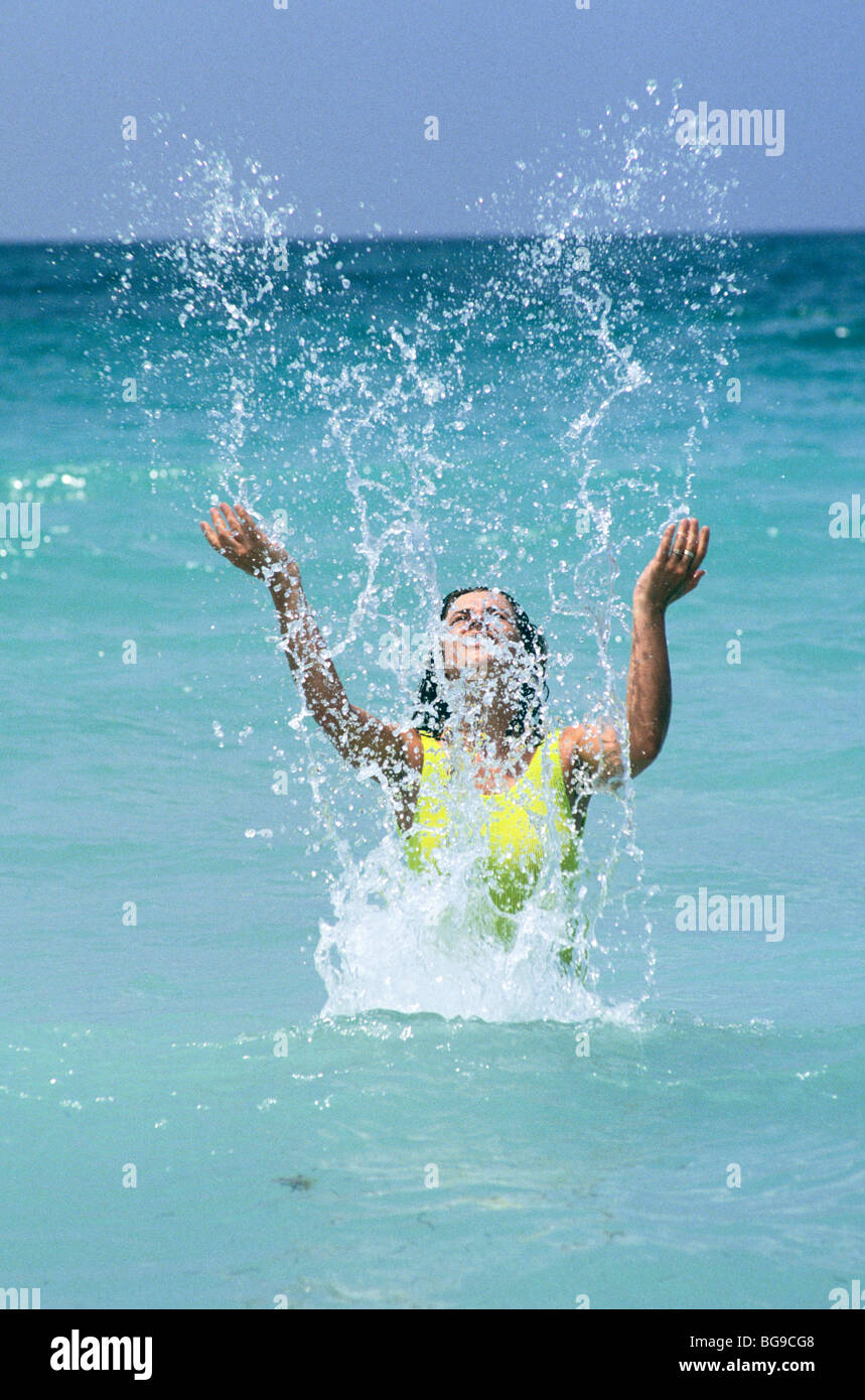Woman splashing in water hi-res stock photography and images - Alamy