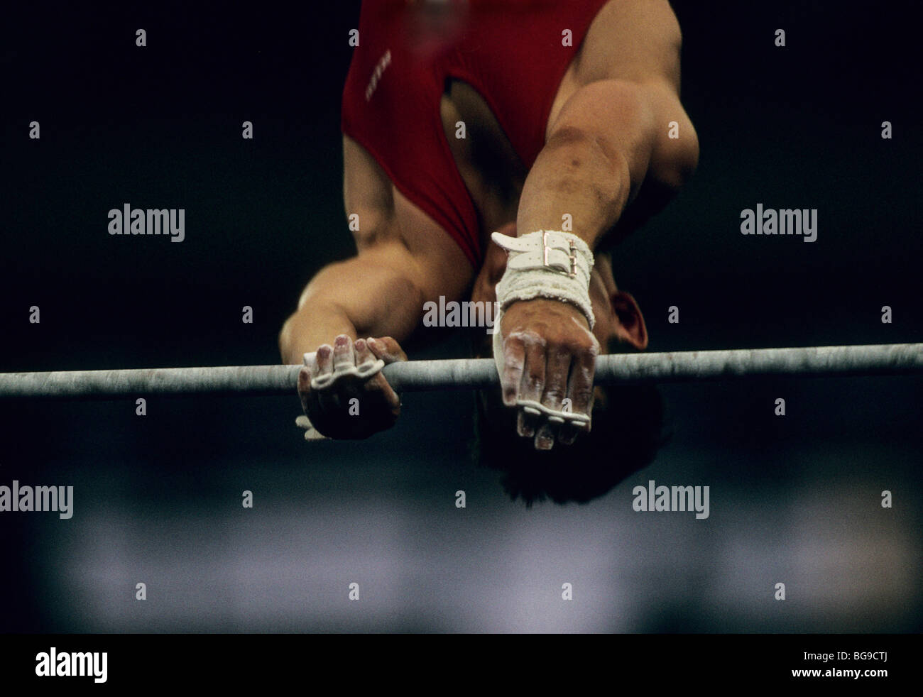 gymnast performing on high bar Stock Photo Alamy