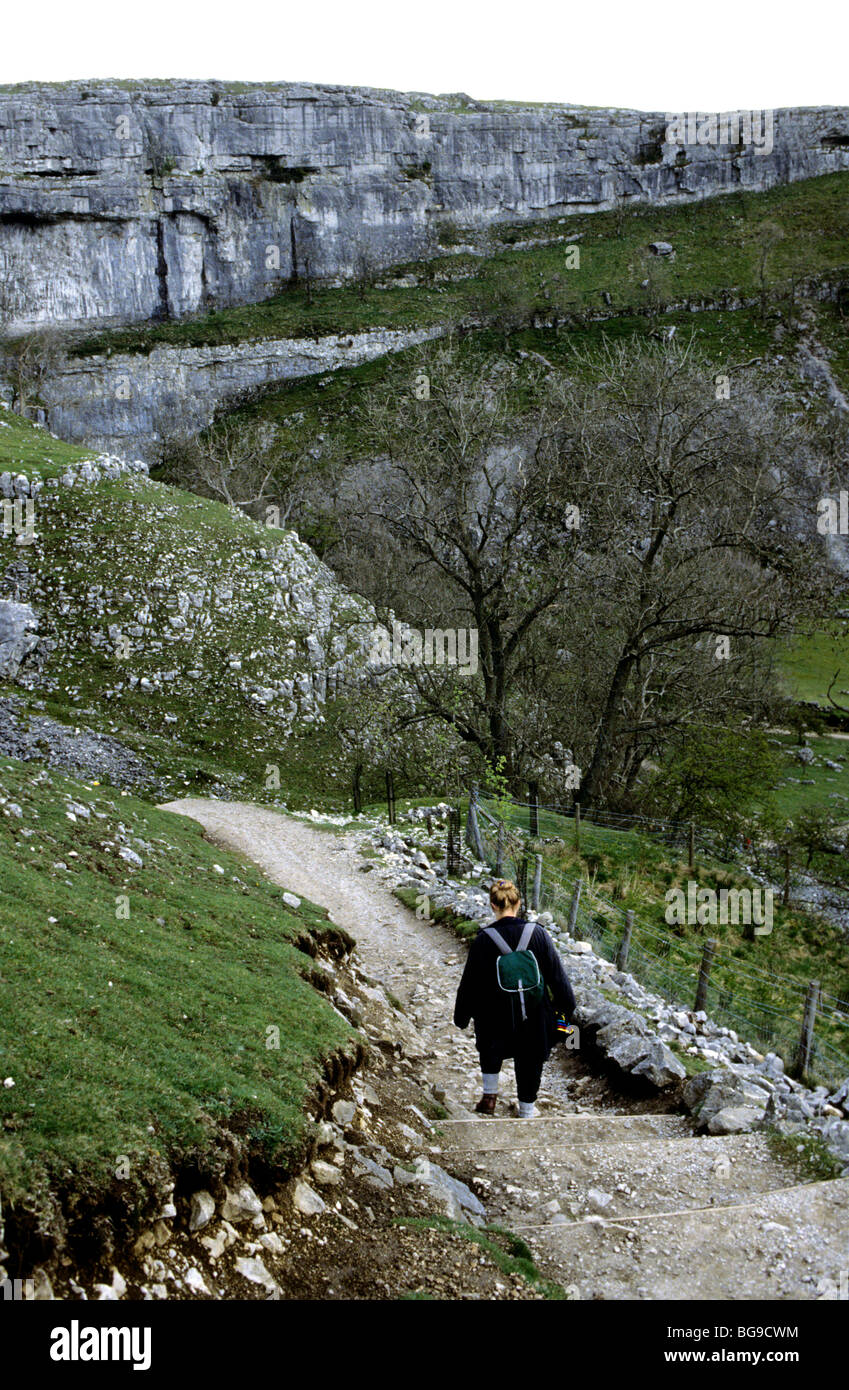 Woman walking down a rocky step path Stock Photo - Alamy