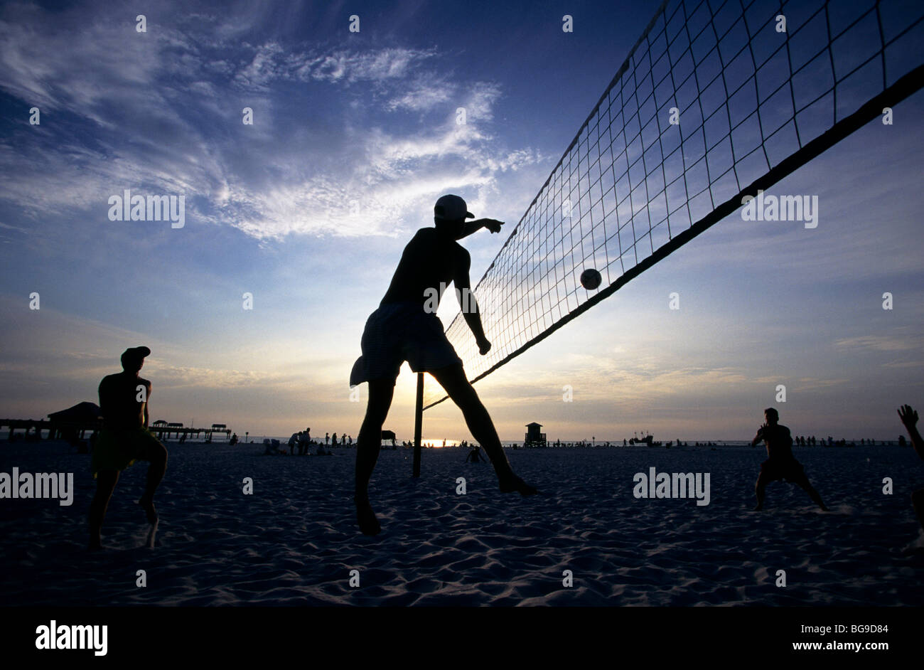 Beach volleyball match at sunset Stock Photo Alamy