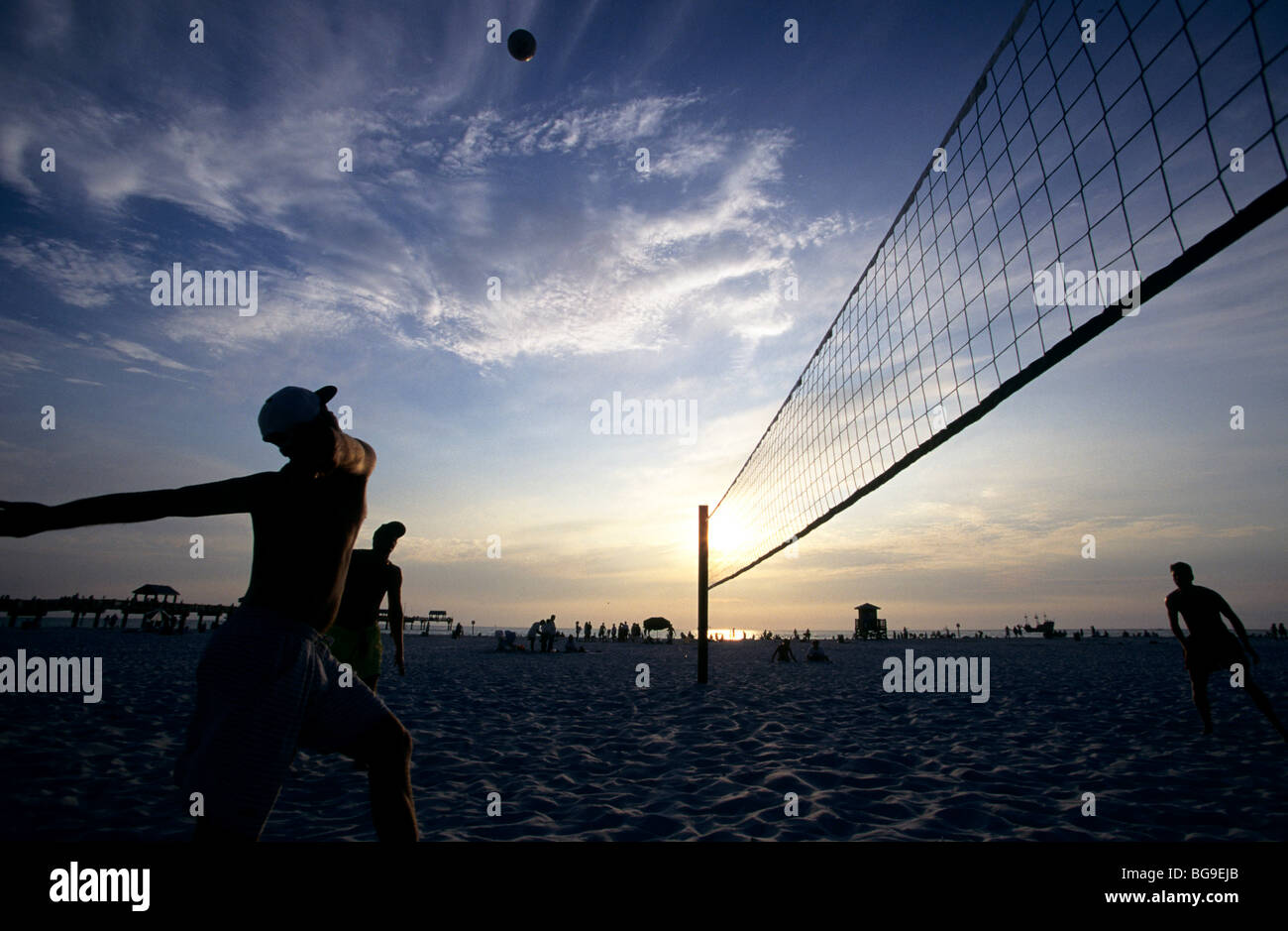 Beach volleyball match at sunset Stock Photo Alamy