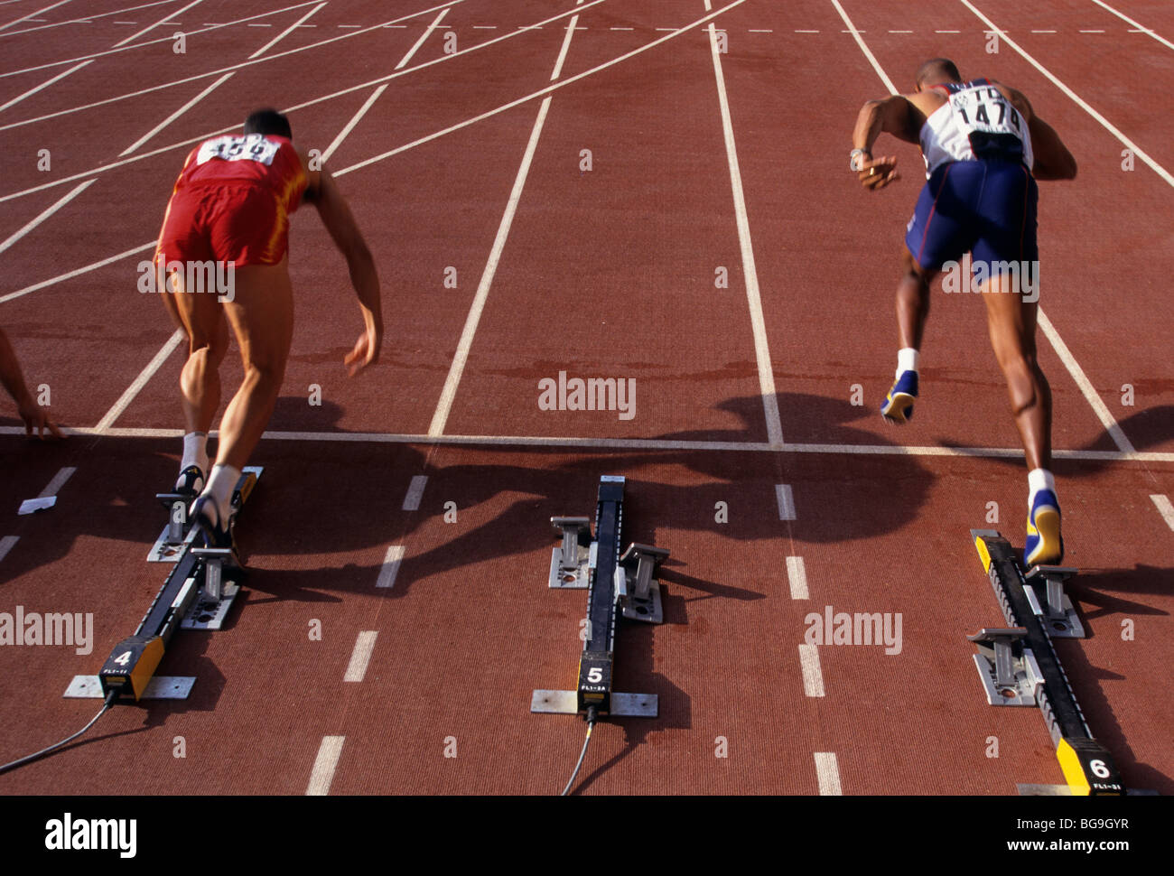 Two sprinters leaving their starting blocks Stock Photo Alamy