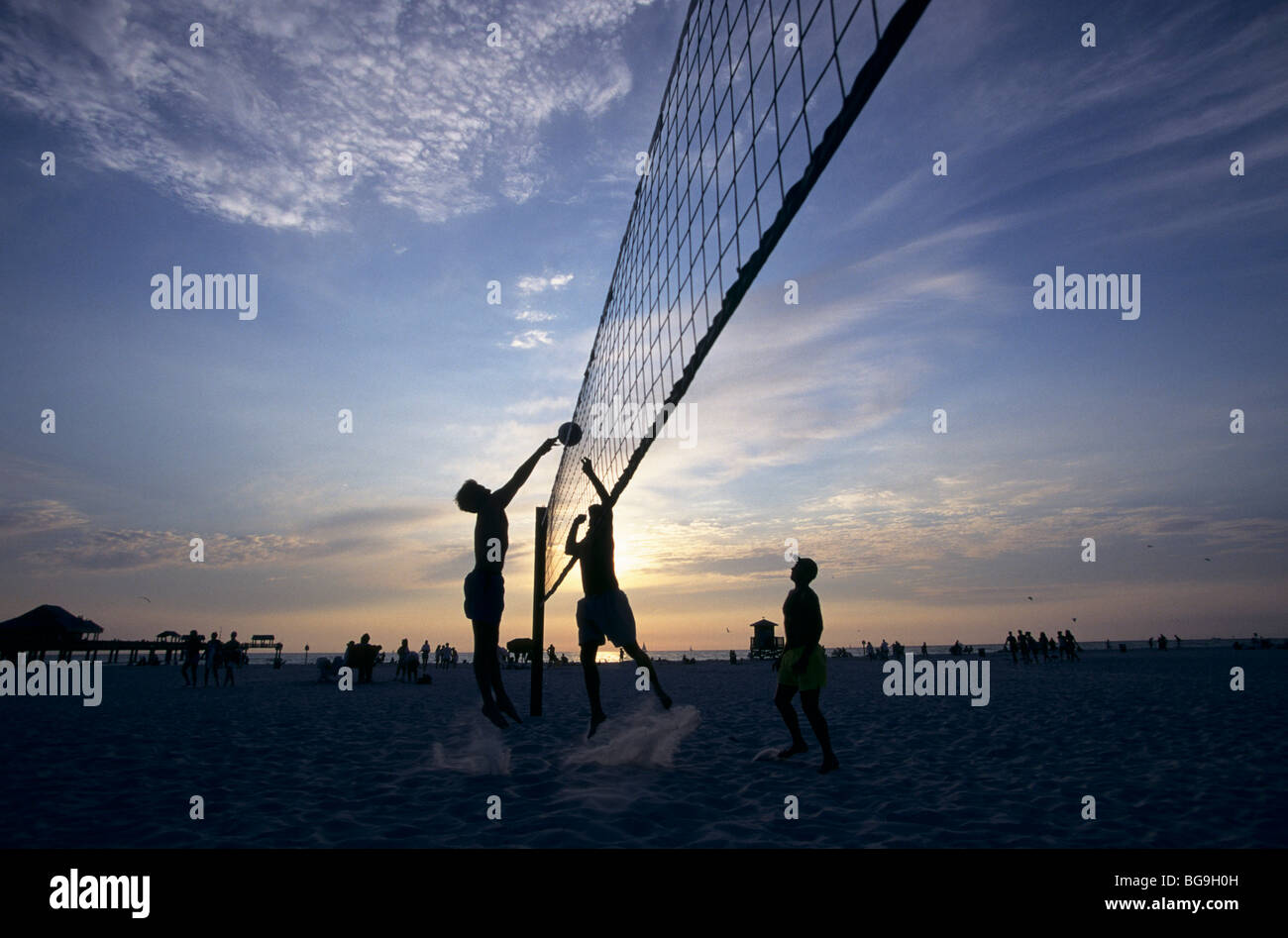 Beach volleyball match at sunset Stock Photo Alamy