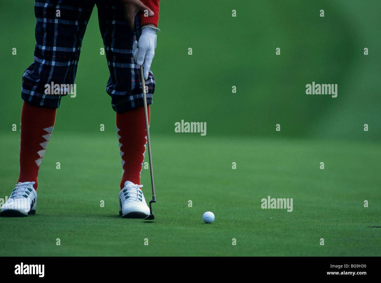 Golfer in plus fours putts on a smooth green Stock Photo