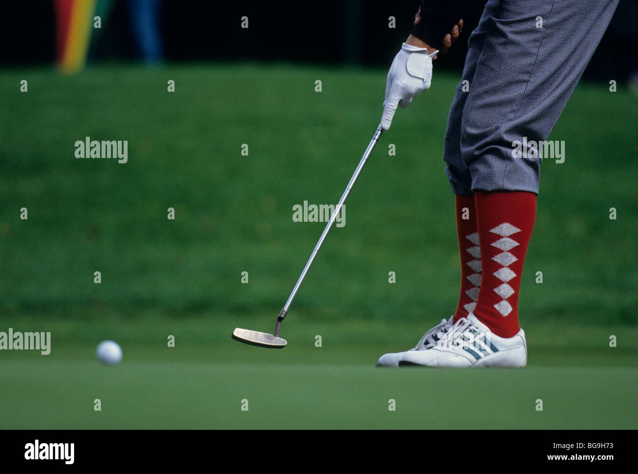 Golfer in plus fours putting a shot Stock Photo