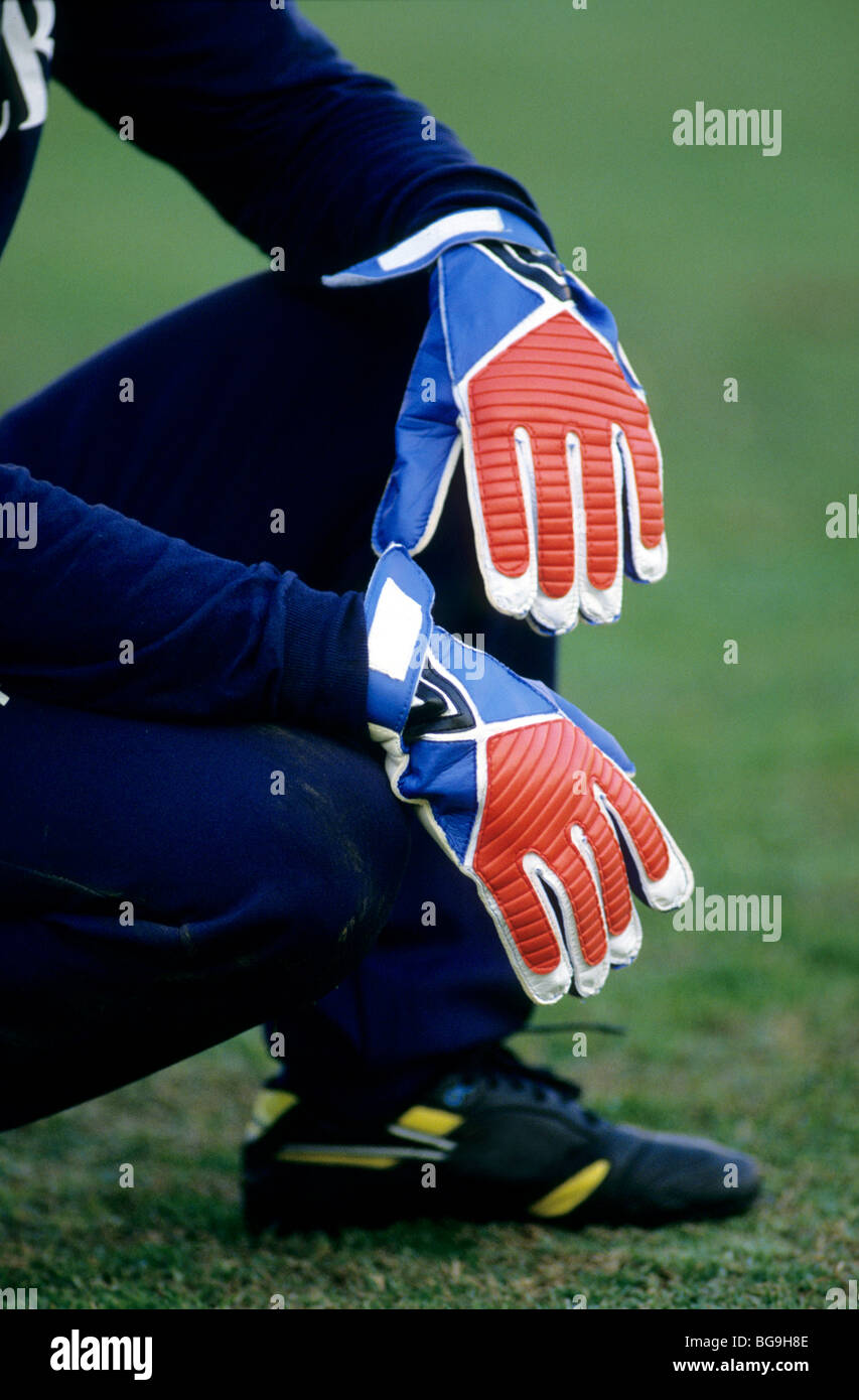 Goal keeper sitting on a pitch Stock Photo - Alamy