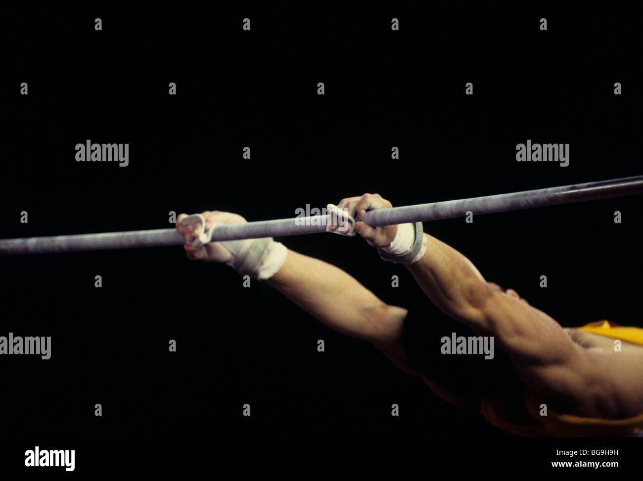 gymnast performing on high bar Stock Photo Alamy