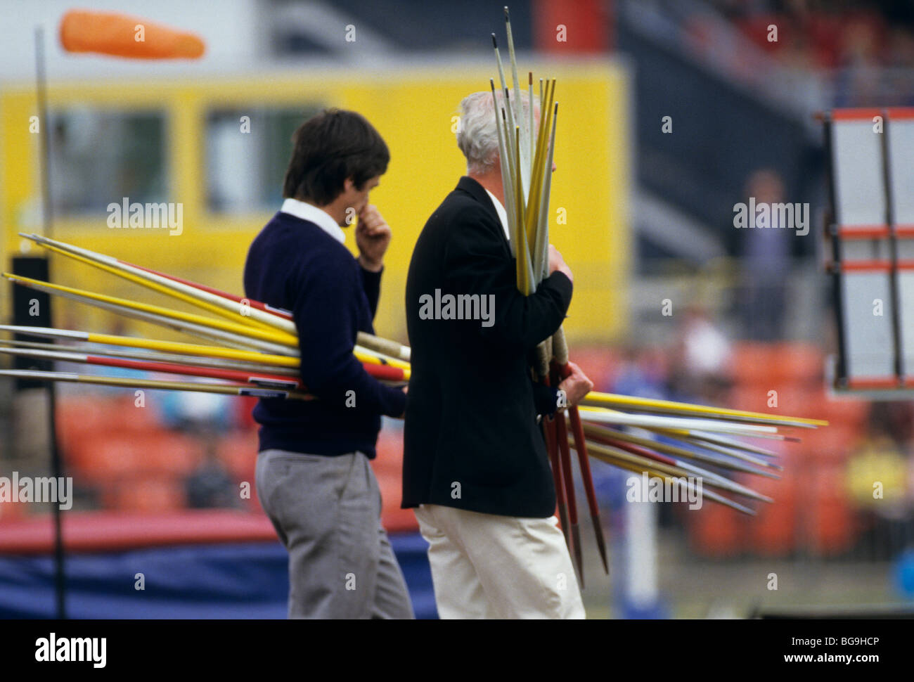 Officials carrying javelins Stock Photo Alamy