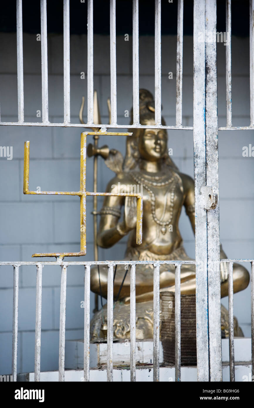 A Buddha statue and swastika at Tibetan Buddhist monastery in Ghoom, Darjeeling, India. Stock Photo