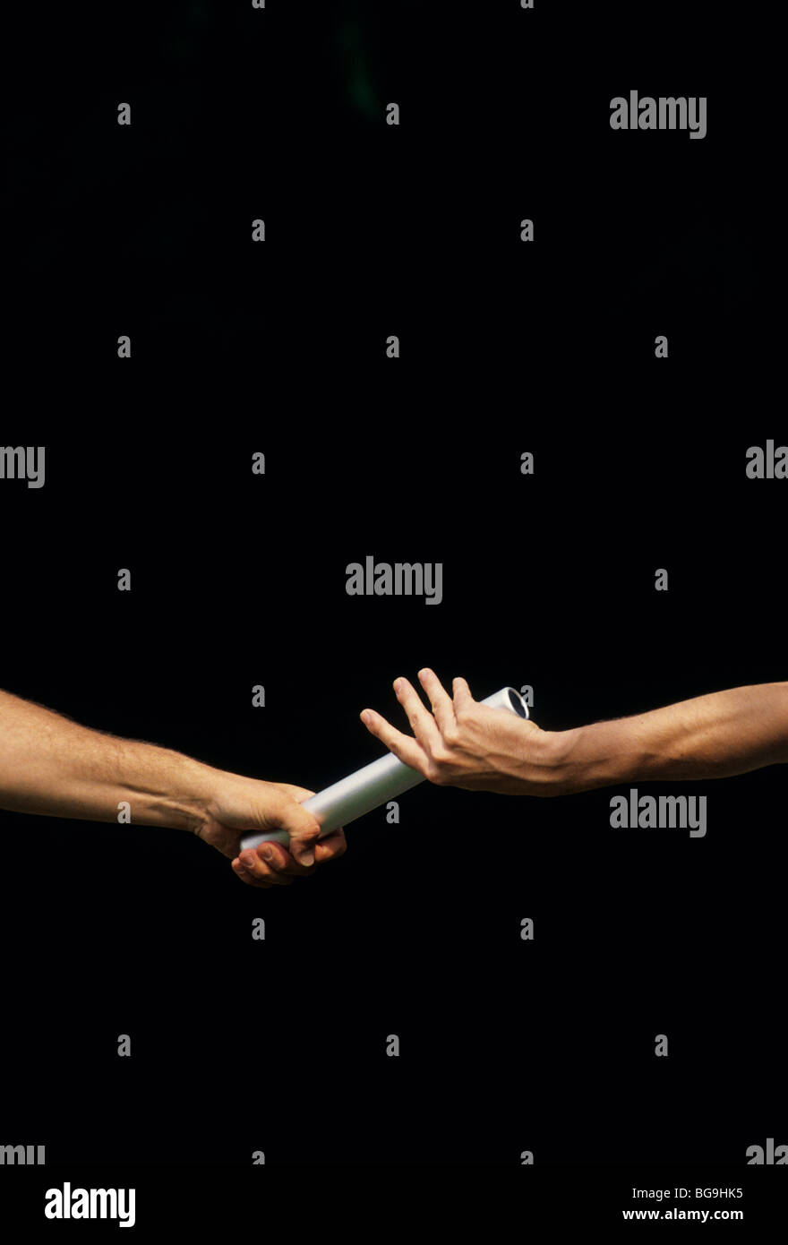Two athletes passing a baton Stock Photo - Alamy