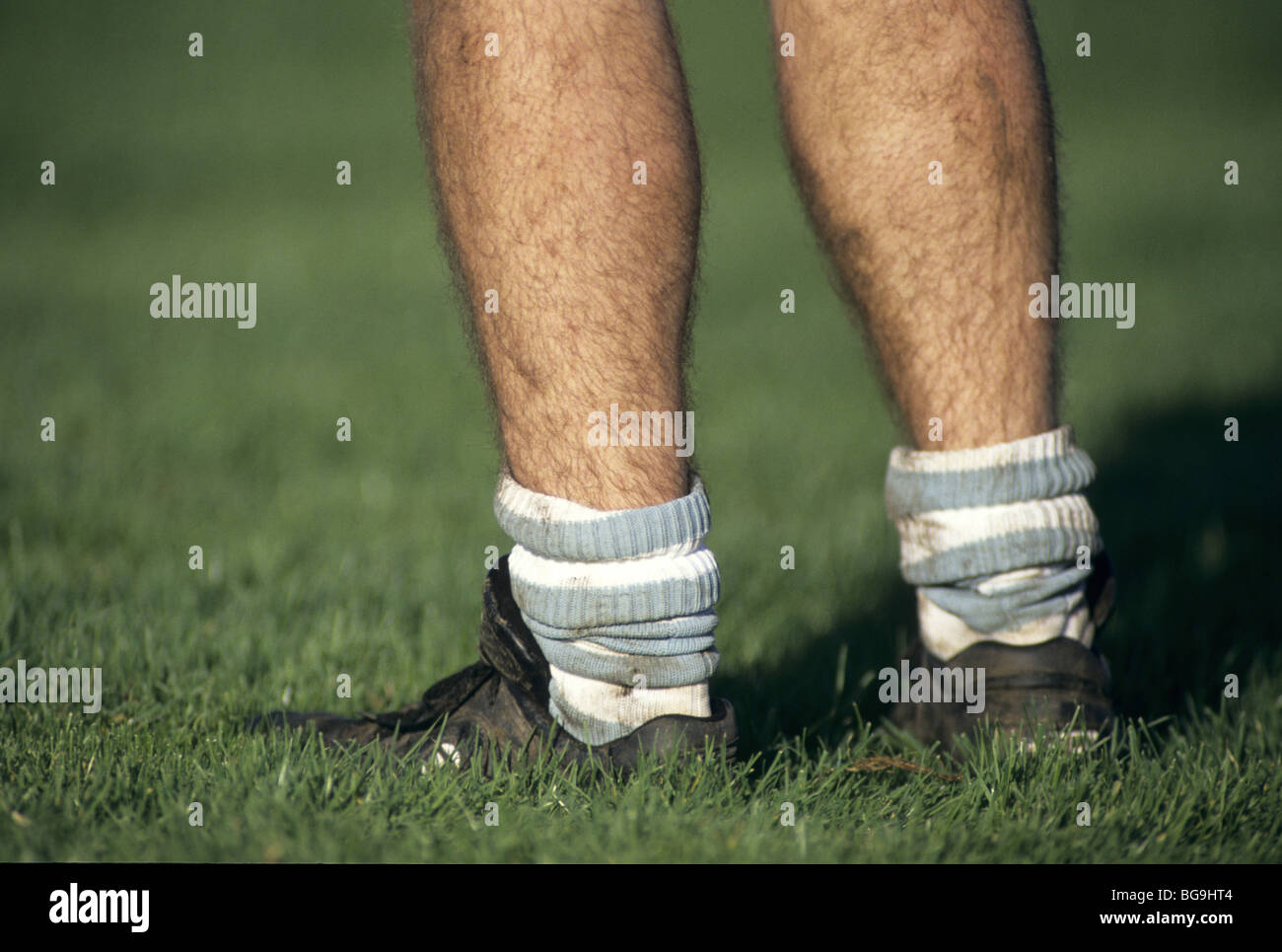 Rugby player in muddy socks and boots Stock Photo Alamy