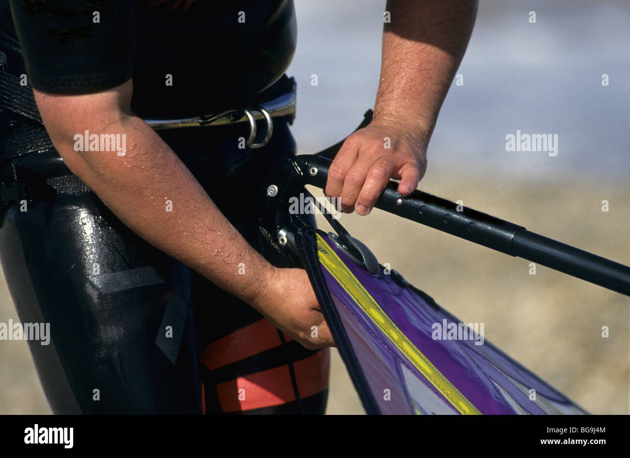 Windsurfer adjusting sail Stock Photo Alamy