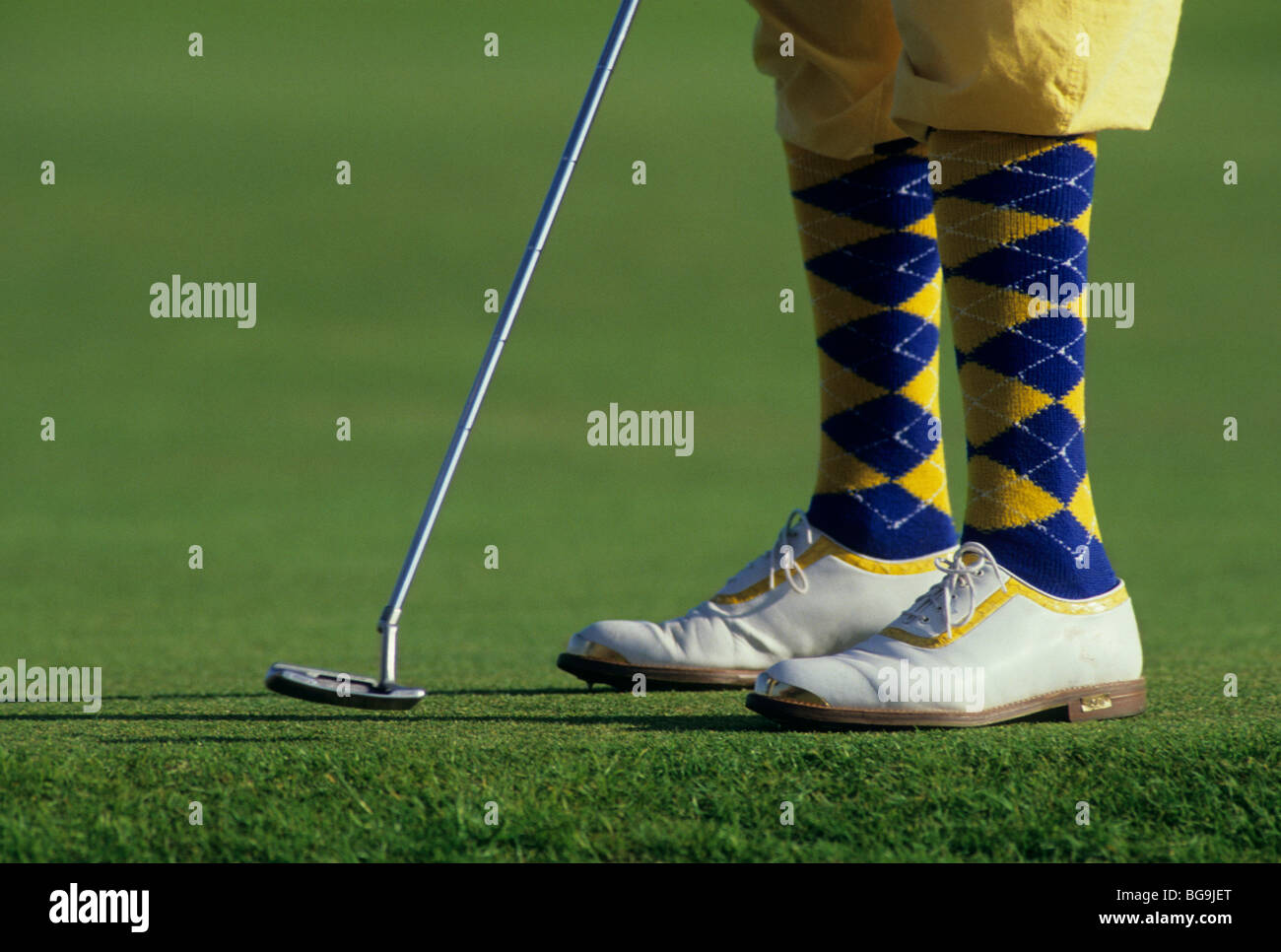 Golfer in plus fours with a putter Stock Photo
