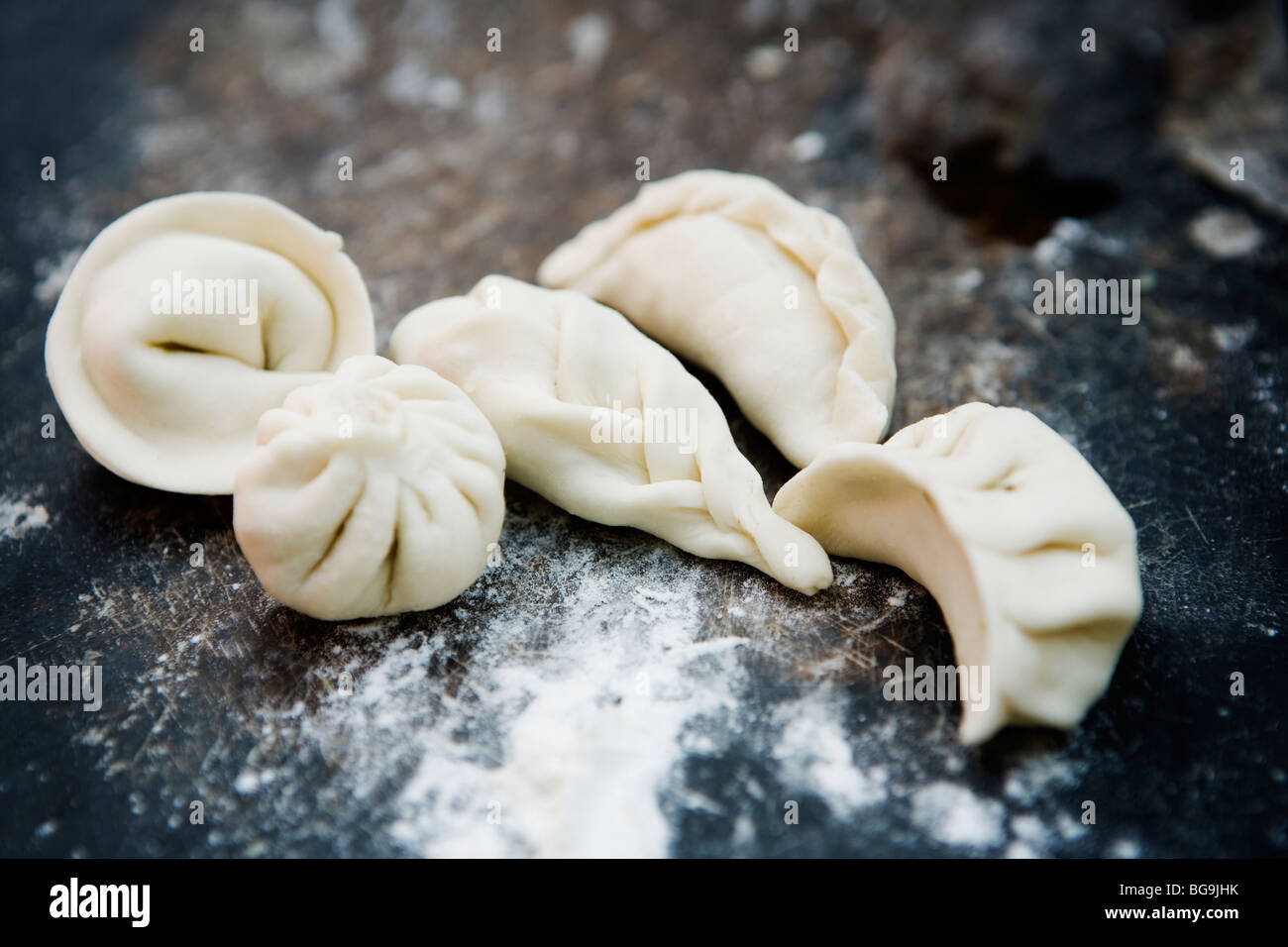 Different shapes of dumplings (Tibetan momo & Russian pelmeni) at a cooking class in Darjeeling, India. Stock Photo