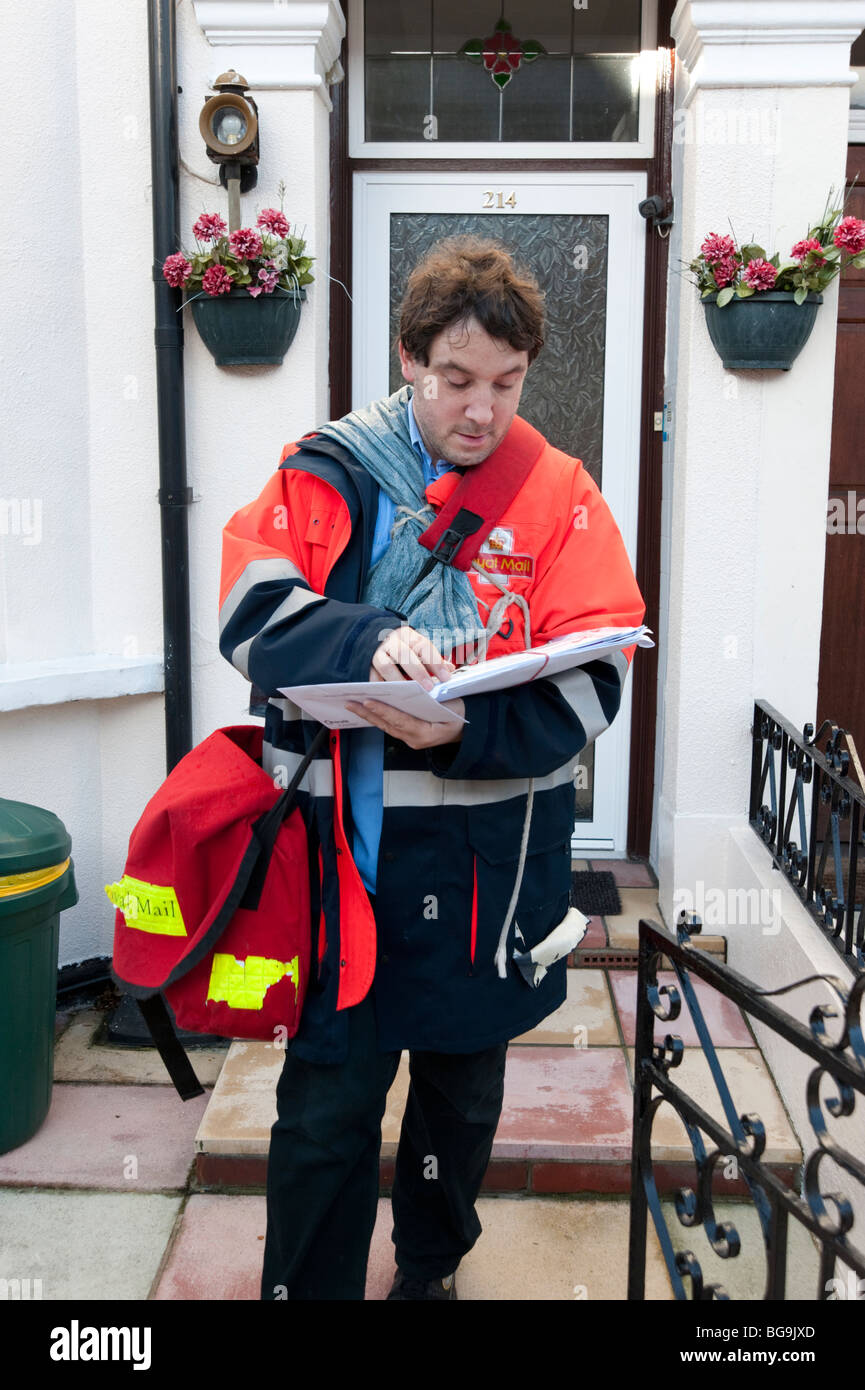Postman delivering letters, England, UK Stock Photo