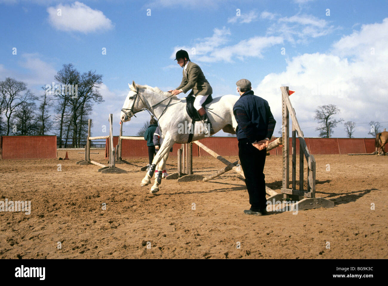 Man jumping his horse during a lesson Stock Photo Alamy