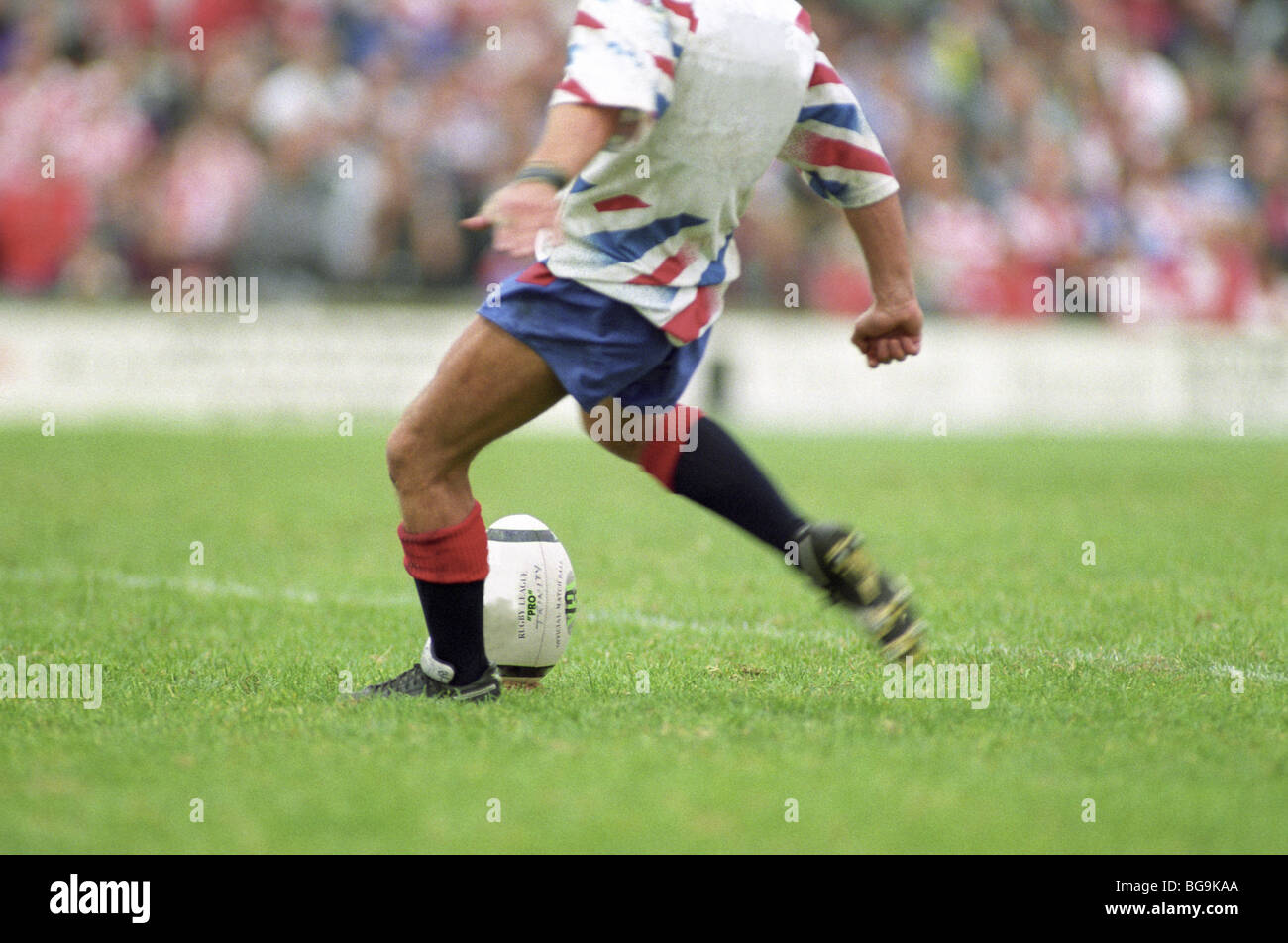 Rugby player kicks the ball off the tee Stock Photo Alamy