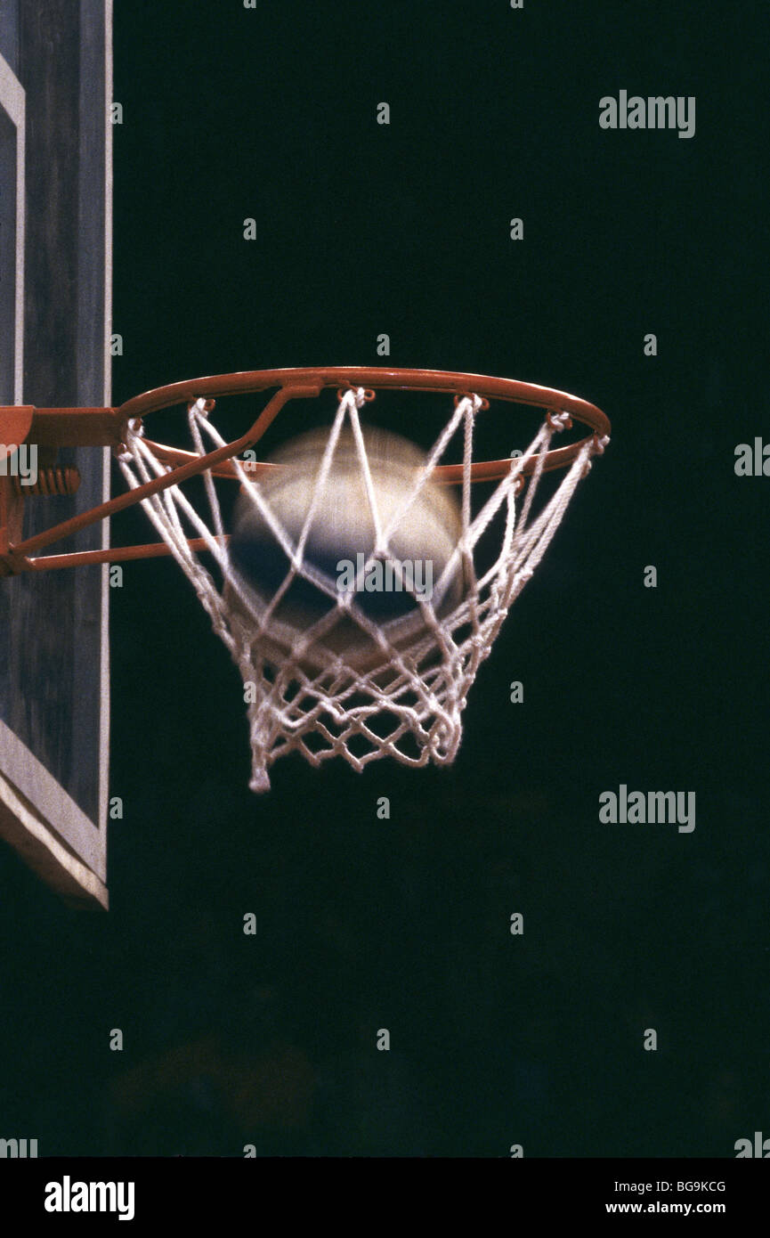 Basketball going through a hoop Stock Photo Alamy