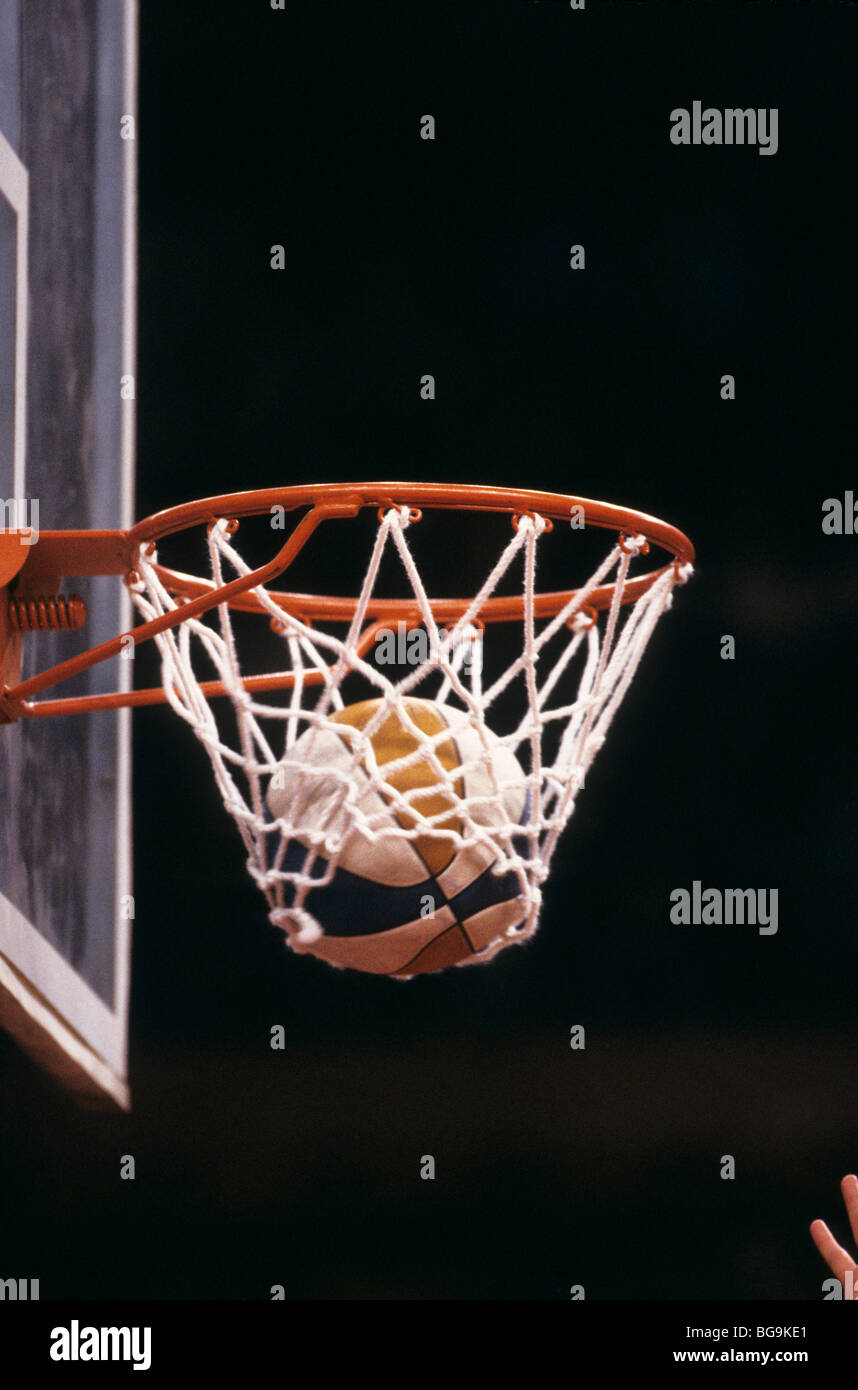 Basketball going through a hoop Stock Photo Alamy