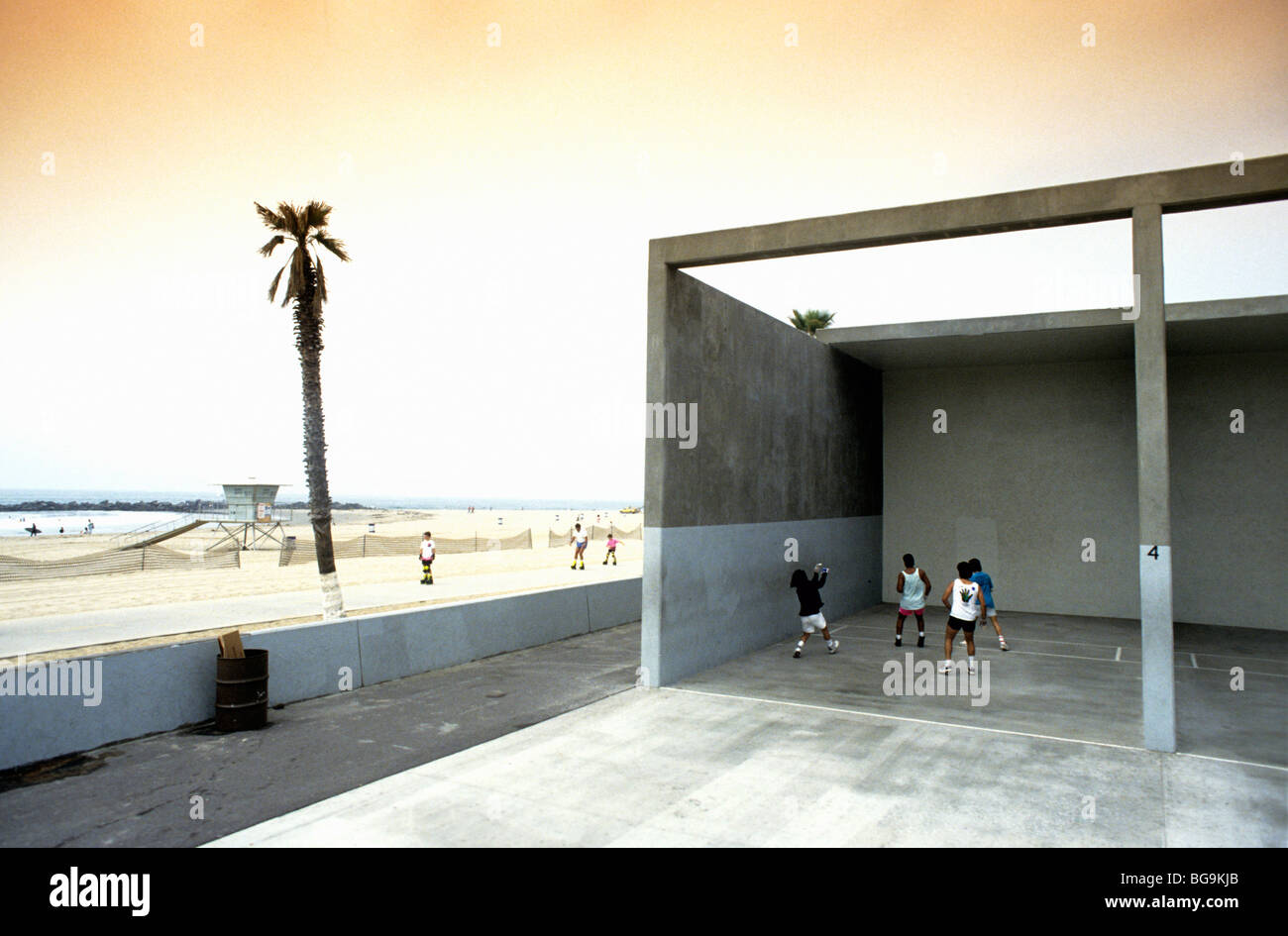 Group of young men playing handball by the beach Stock Photo