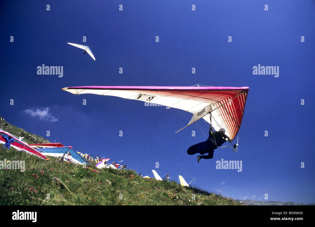 Hang glider taking off from a busy hill side Stock Photo Alamy