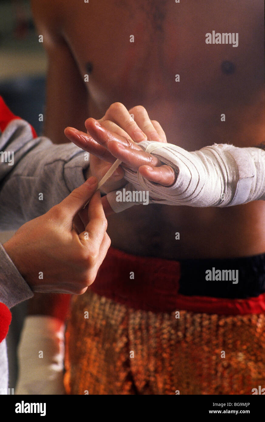 Trainer taping up a boxers hand Stock Photo - Alamy