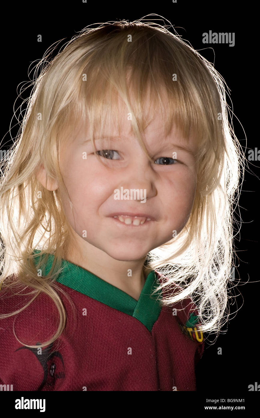 Portrait Of Funny Little Girl With Blonde Hair On Black Background