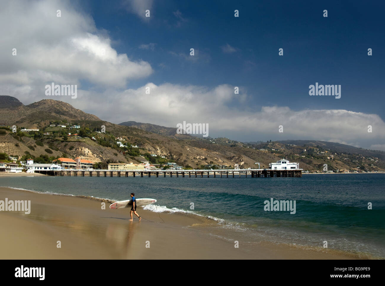 Surfer on Malibu Beach Near Pier Stock Photo