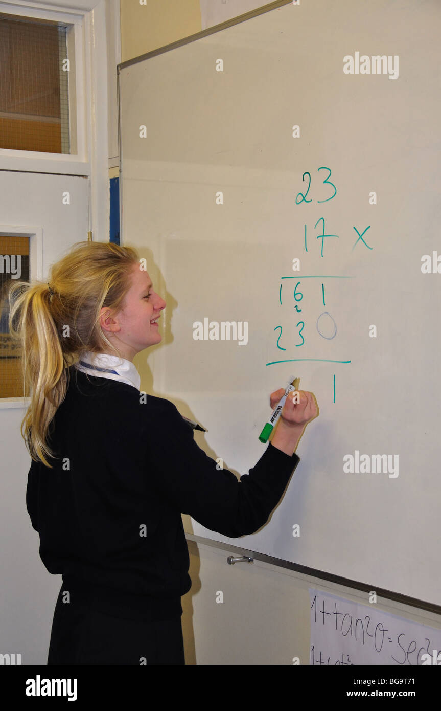 Girl writing on board in classroom, Heathfield St.Mary's School, London Road, Ascot, Berkshire, England, United Kingdom Stock Photo