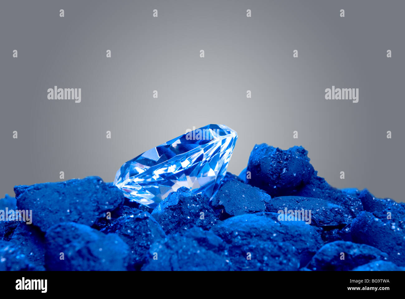 A diamond in a pile of coal shows a long awaited precious gem evolve. Stock Photo