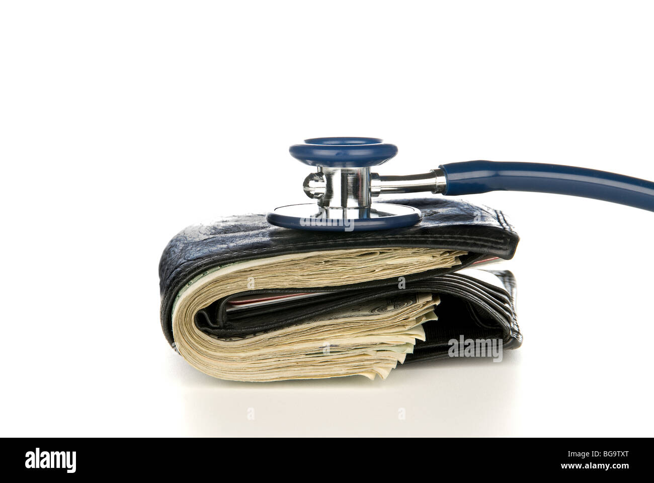 A leather wallet being examined with a stethoscope. Good for medical and financial inferences, high costs, being broke. Stock Photo