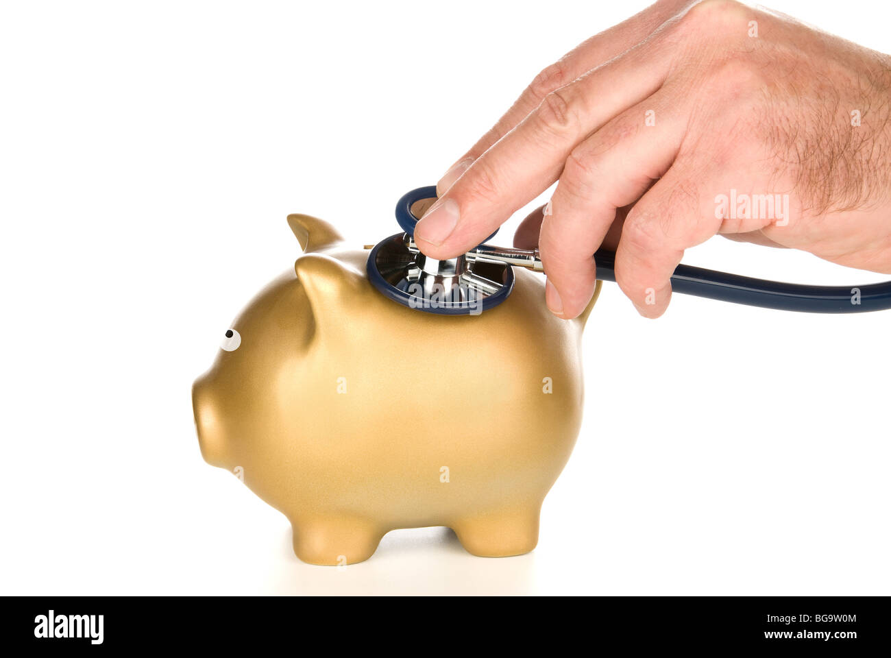 A golden piggy bank is being examined for life after tough economic times. Stock Photo