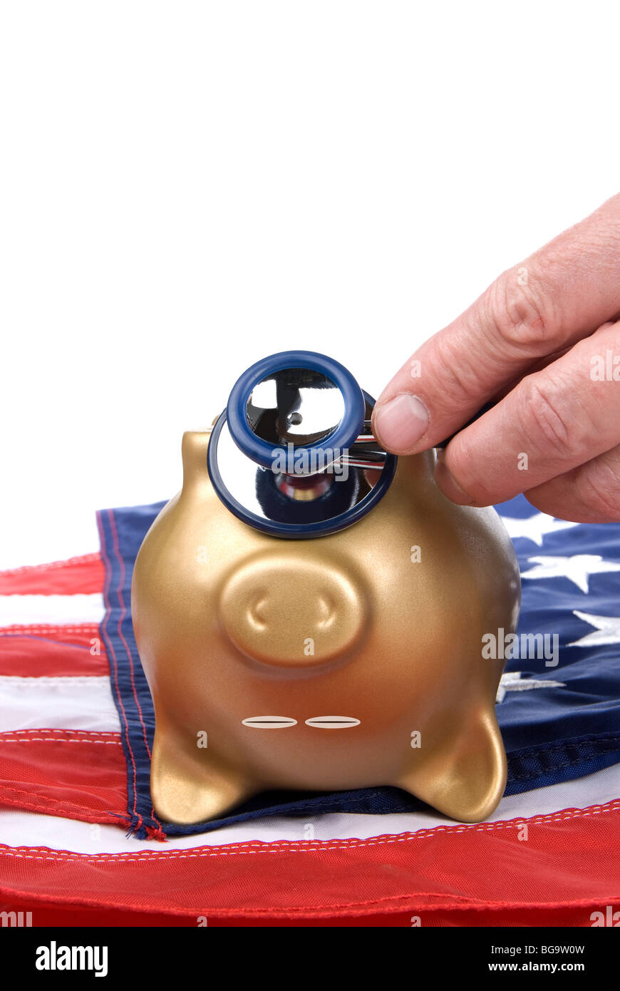 An upside down, nearly dead piggy bank on an American flag is being examined for signs of economic and financial life. Stock Photo