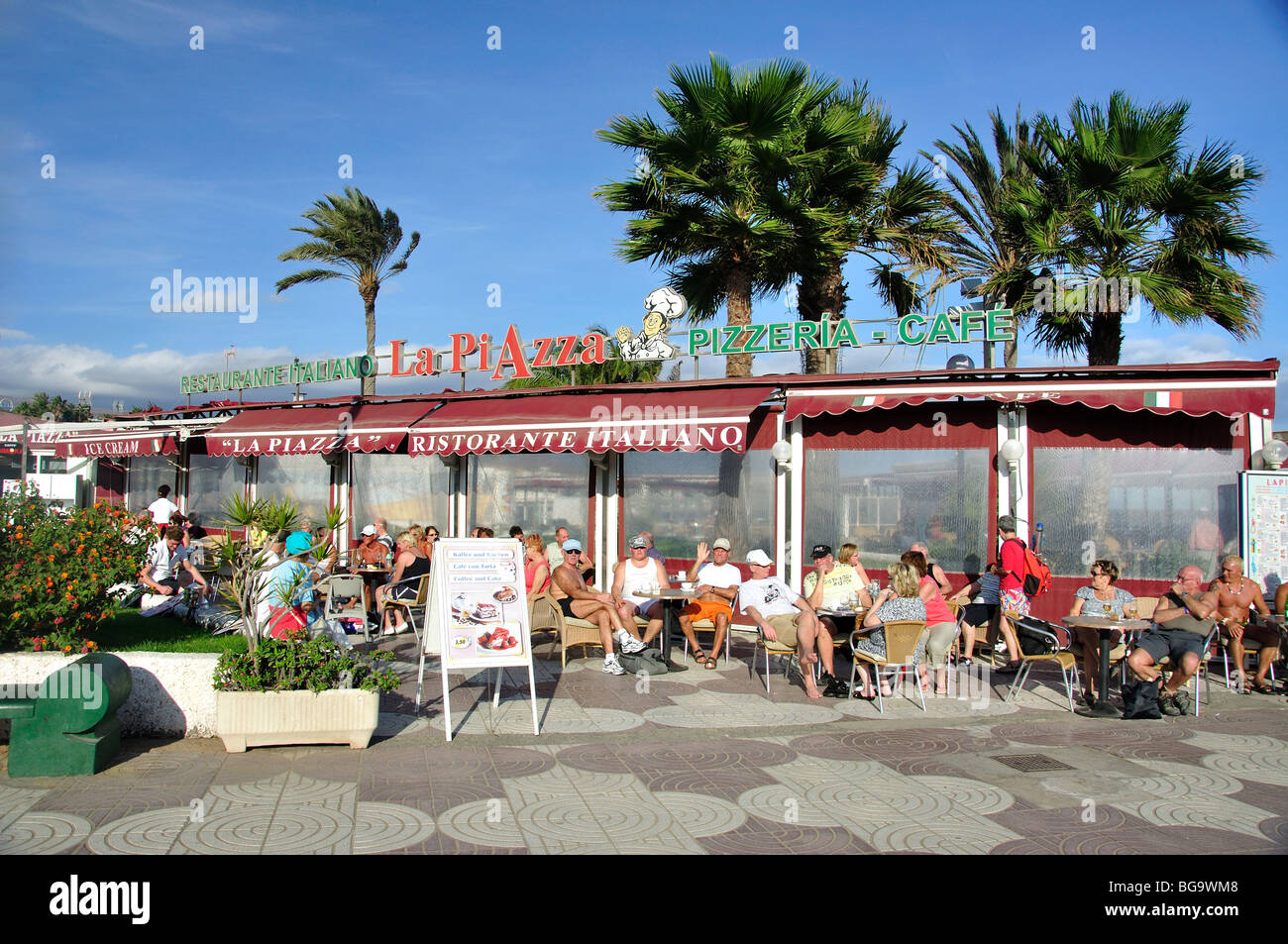 Outdoor cafes on beach promenade, Playa del Ingles, San Bartolome de Tirajana Municipality Gran Canaria, Canary Islands, Spain Stock Photo