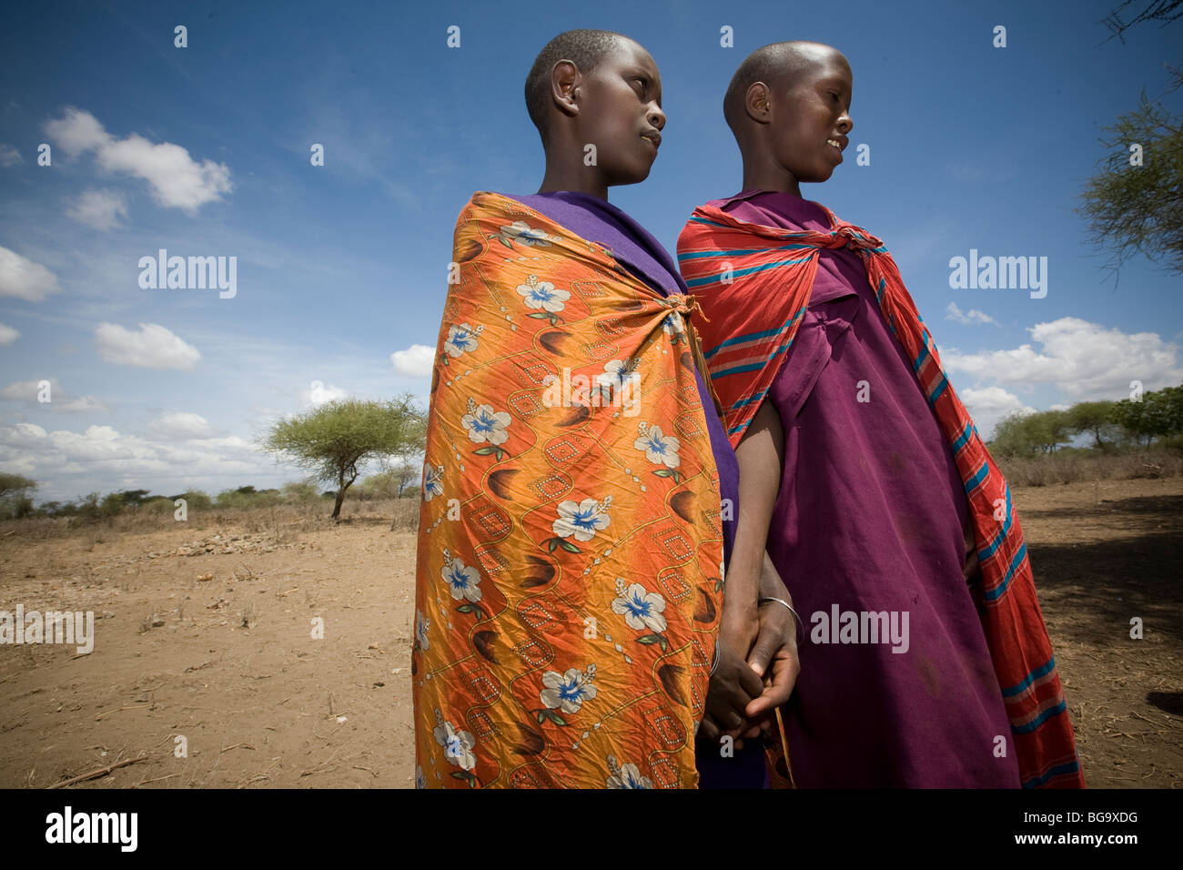 Girls in colorful dress - Maasai village of Tindagani, Kilimanjaro Region, Tanzania. Stock Photo