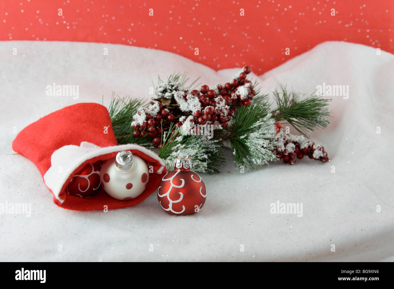 red and white Christmas baubles spilling from stocking Stock Photo